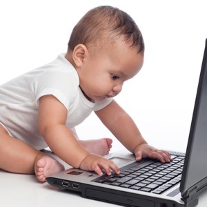 Picture of a baby at a laptop computer.